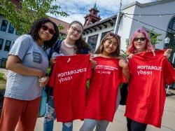 Four Summer Bridge students pose with red t-shirts outside of Cole Hall at UC's College Prep Cookout.